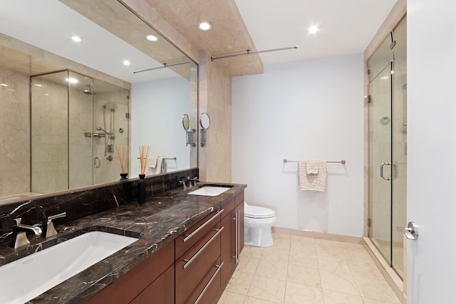 full bathroom with recessed lighting, a stall shower, marble finish flooring, double vanity, and toilet