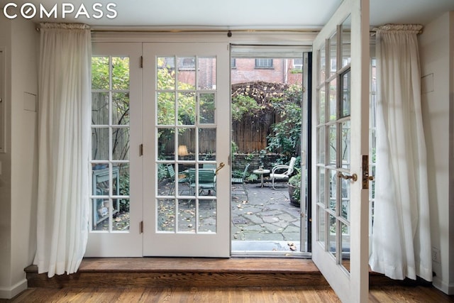 doorway with hardwood / wood-style floors and french doors