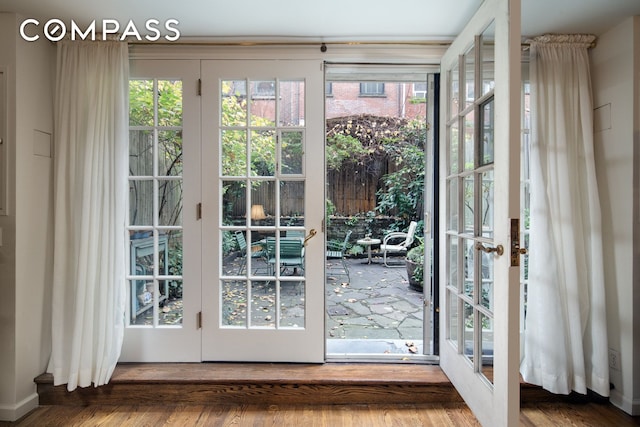 entryway with hardwood / wood-style floors and french doors