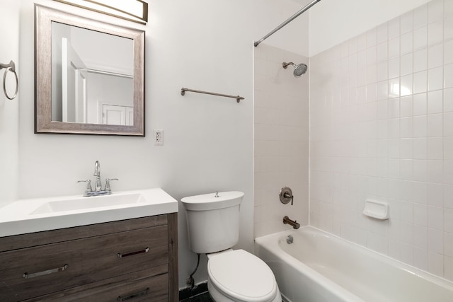 full bathroom with tiled shower / bath, vanity, and toilet