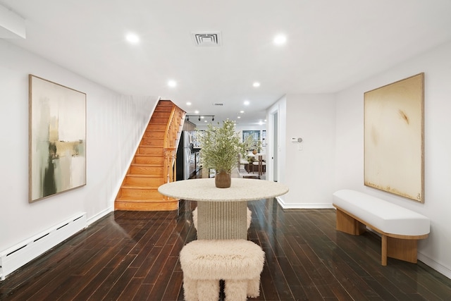 interior space featuring baseboard heating and dark hardwood / wood-style flooring