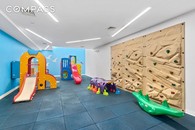 recreation room featuring visible vents and baseboards