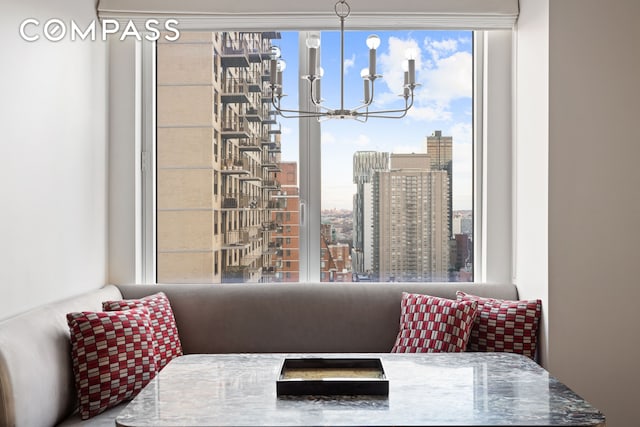 dining room featuring a view of city and an inviting chandelier