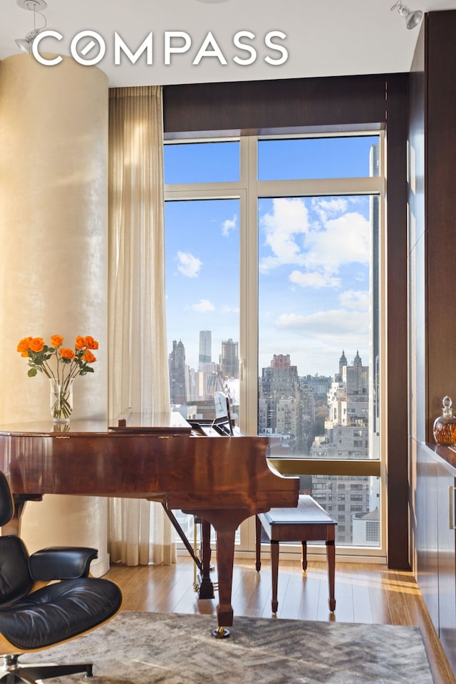 living area with a view of city and wood finished floors