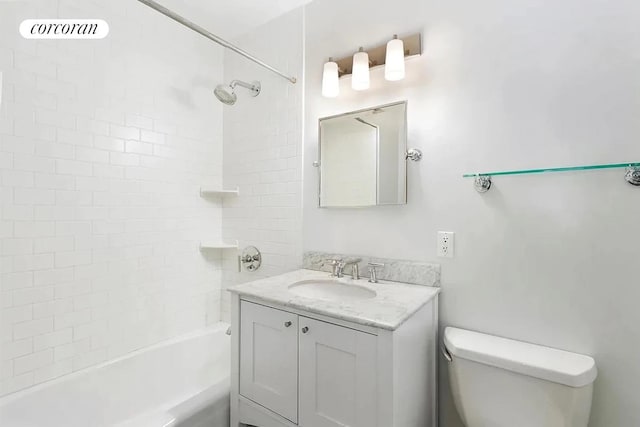 bathroom featuring toilet, vanity, and bathtub / shower combination