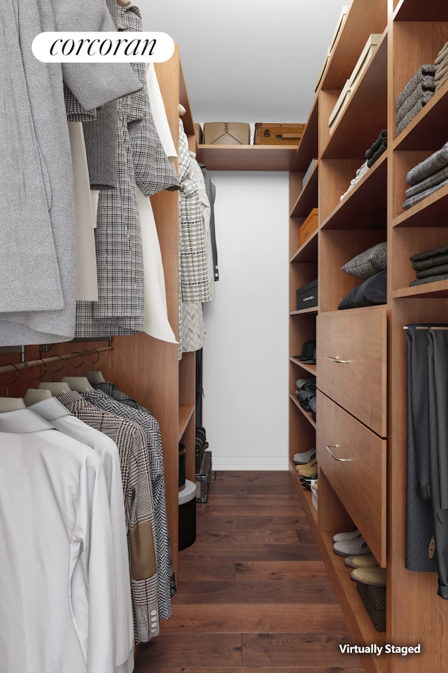 walk in closet with wood finished floors