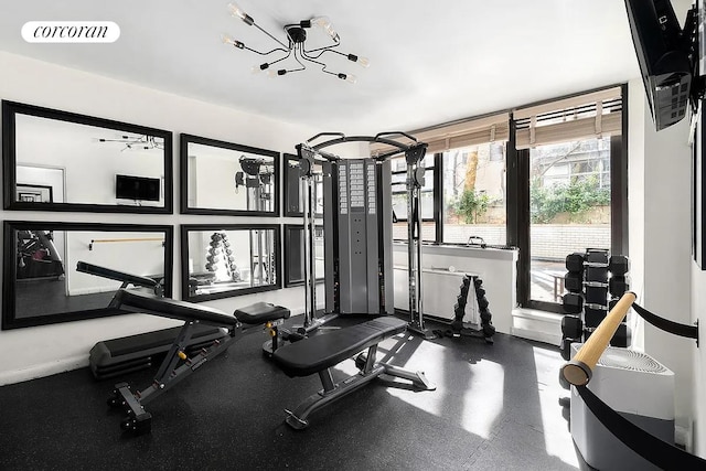 exercise area with an inviting chandelier and visible vents