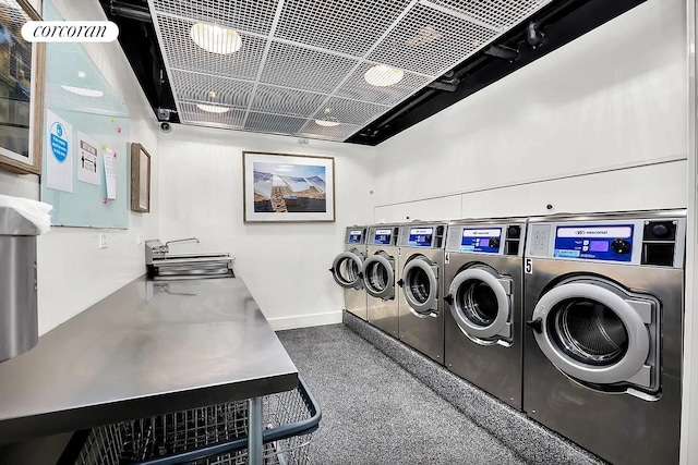 shared laundry area featuring washer and dryer and baseboards