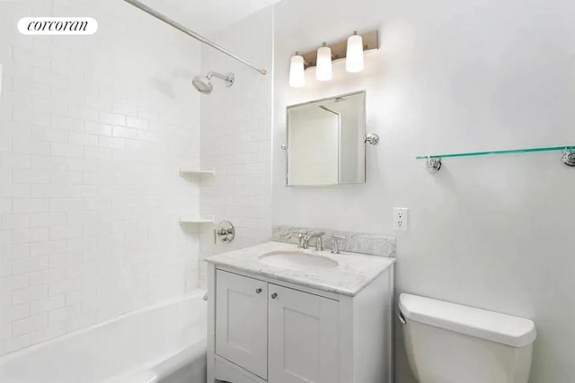 full bathroom featuring toilet, tiled shower / bath combo, and vanity