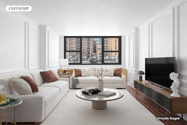 living area with visible vents, wood finished floors, and a decorative wall