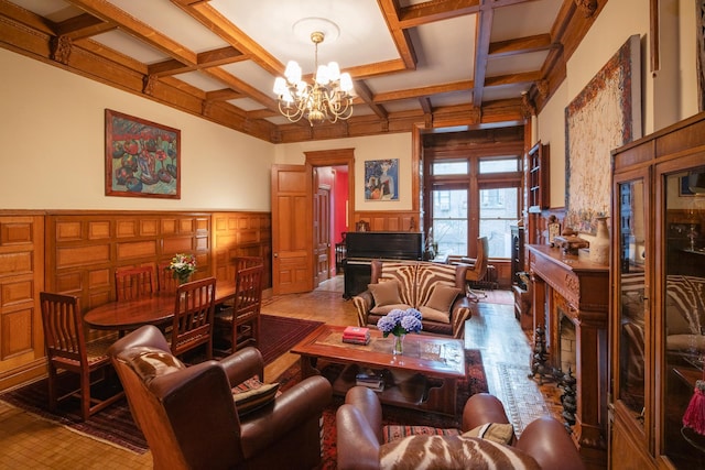 living area featuring coffered ceiling, a chandelier, beam ceiling, and wainscoting