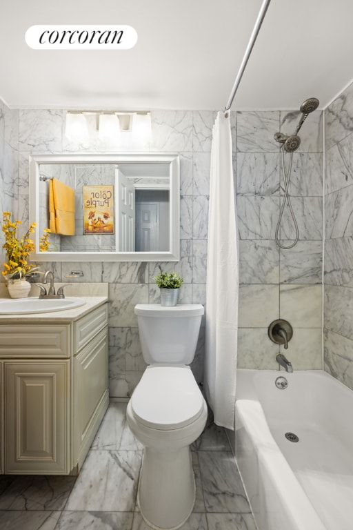 full bathroom with shower / tub combo, vanity, tile walls, and toilet