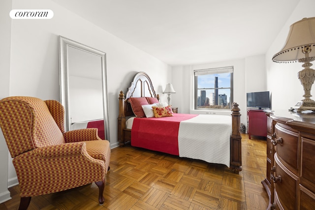 bedroom with dark parquet flooring