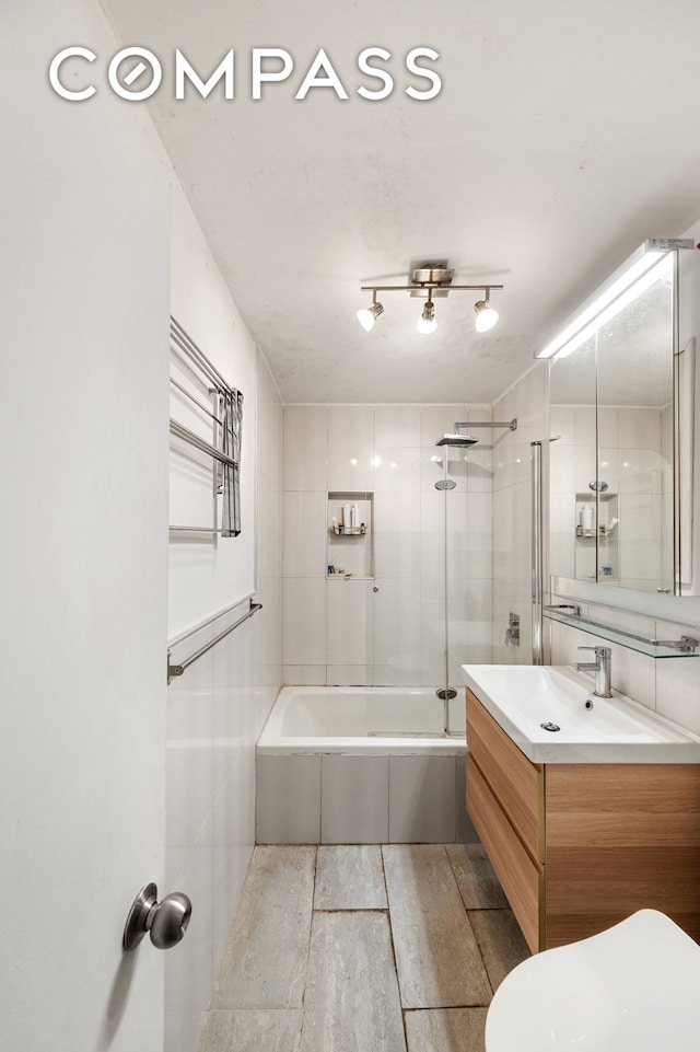 bathroom with shower / tub combination, vanity, wood finished floors, and toilet