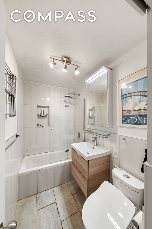 bathroom with toilet, tub / shower combination, and vanity