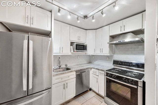 kitchen with white cabinets, sink, light stone counters, and stainless steel appliances