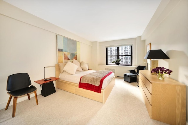 carpeted bedroom featuring radiator