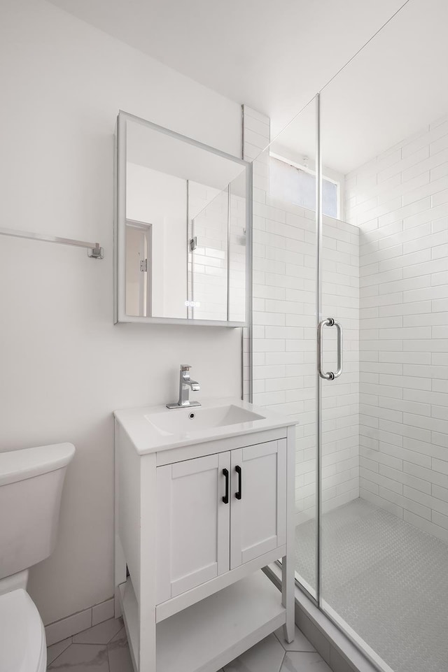 full bathroom featuring baseboards, toilet, marble finish floor, vanity, and a shower stall