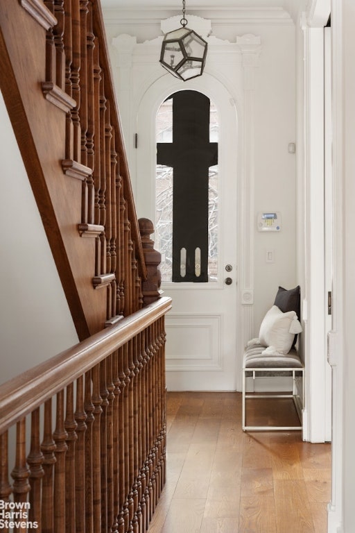 interior space with ornamental molding and light hardwood / wood-style floors