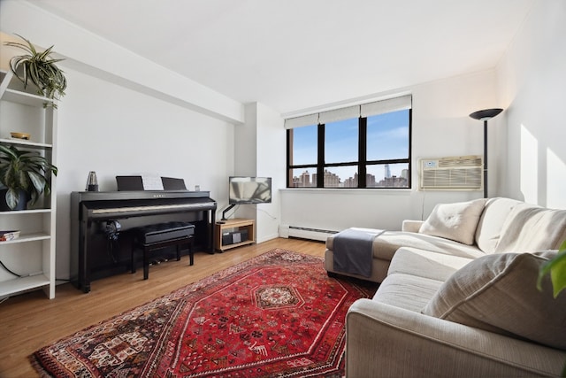 living room featuring hardwood / wood-style floors, a baseboard radiator, and a wall unit AC