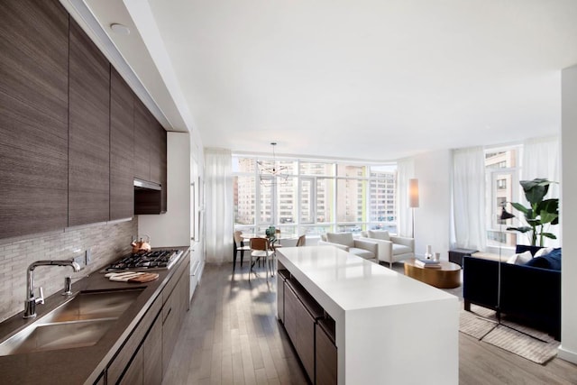 kitchen featuring open floor plan, stainless steel gas stovetop, a sink, and modern cabinets