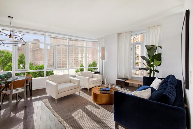 285 W 110th St Unit 2A, New York City, NY 10026 - living room featuring wood finished floors and a chandelier