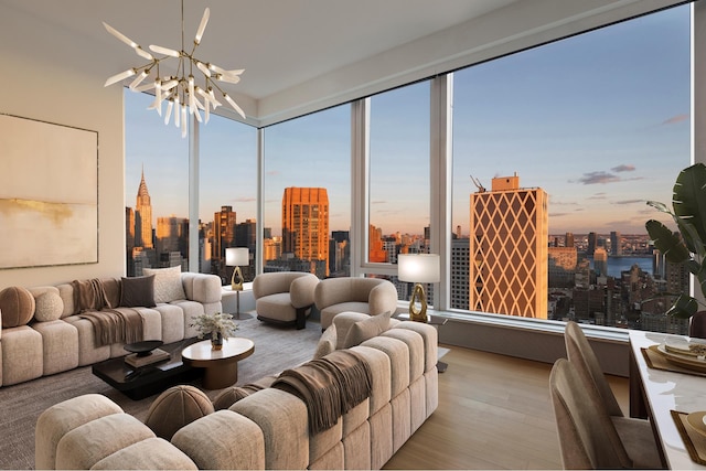 living area with a wealth of natural light, a view of city, a notable chandelier, and wood finished floors