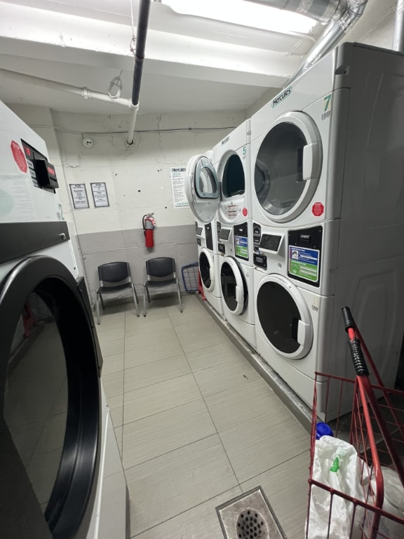 washroom with washer and dryer and stacked washing maching and dryer