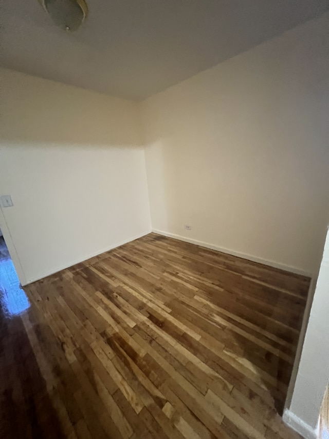 unfurnished room with dark wood-style flooring