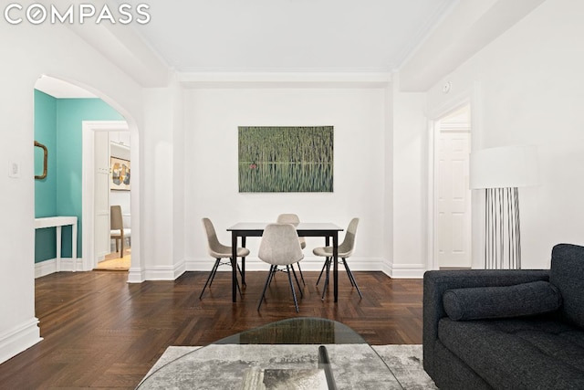 dining room with dark parquet flooring and ornamental molding