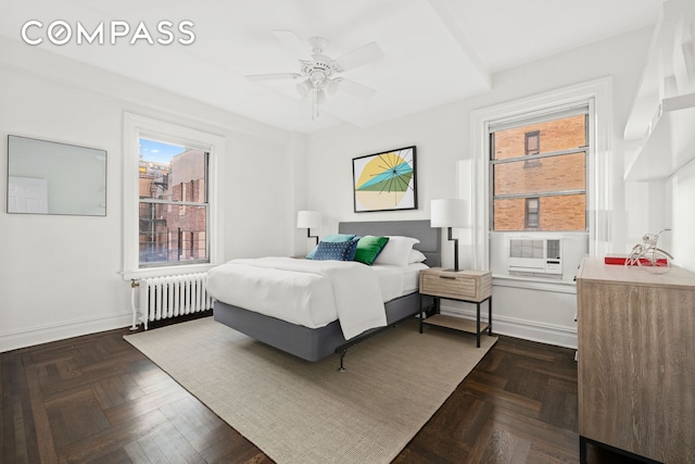 bedroom with baseboards, ceiling fan, cooling unit, and radiator