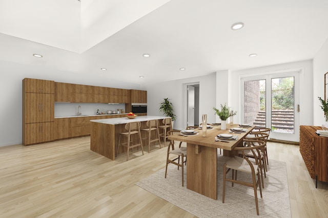 kitchen with modern cabinets, brown cabinets, a center island, light countertops, and a sink