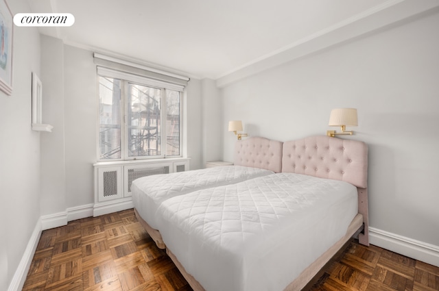 bedroom with dark parquet floors