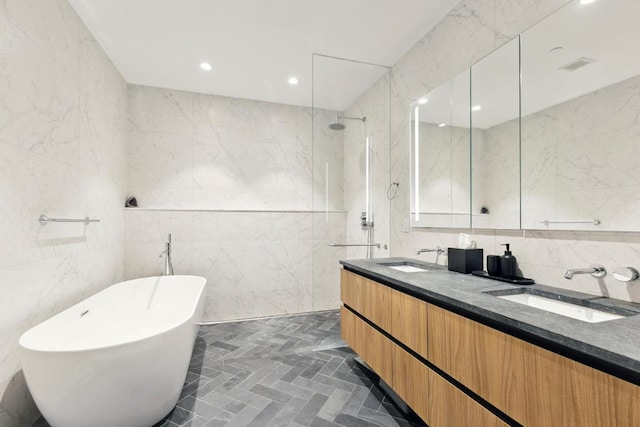 bathroom with tile walls, vanity, and independent shower and bath