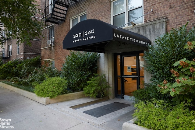 view of exterior entry with brick siding