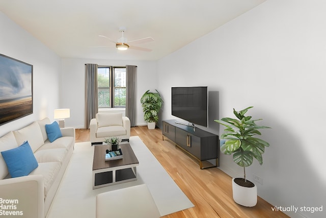 living area with light wood finished floors and ceiling fan