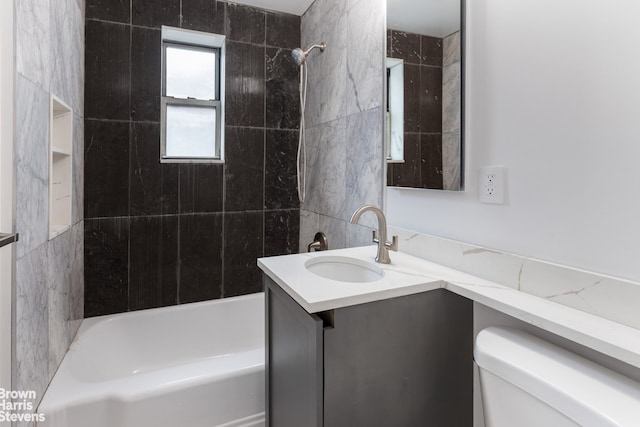 bathroom with washtub / shower combination, vanity, and toilet