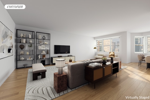 living area with a wealth of natural light, visible vents, and wood finished floors