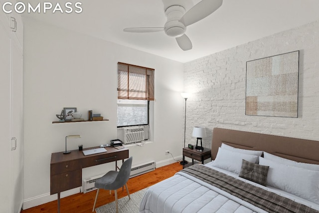 bedroom featuring cooling unit, hardwood / wood-style flooring, and ceiling fan