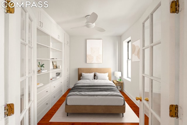 bedroom with multiple windows, wood-type flooring, ceiling fan, and french doors