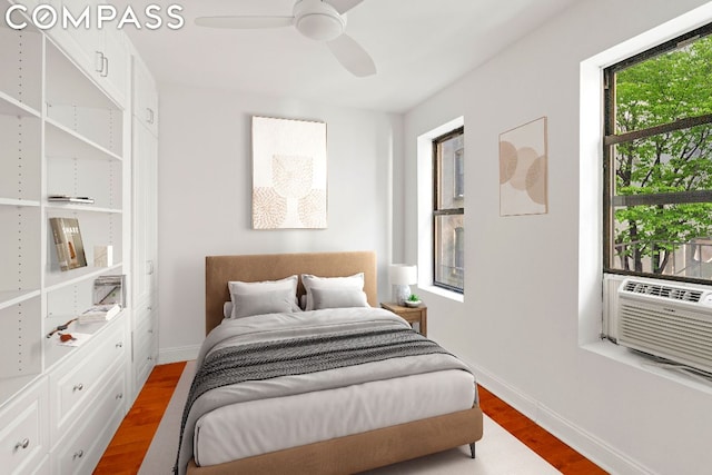 bedroom featuring cooling unit, wood-type flooring, and ceiling fan