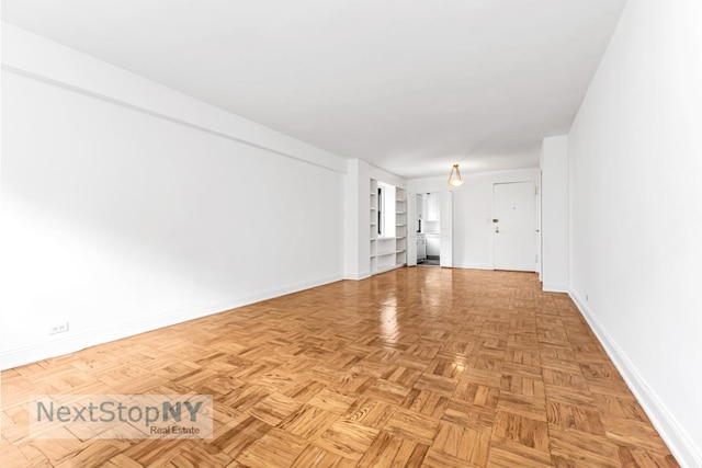 unfurnished living room featuring light parquet floors