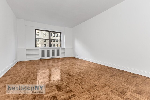 empty room with light parquet floors