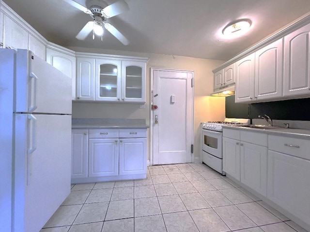 kitchen with white appliances, white cabinetry, sink, ceiling fan, and light tile patterned floors