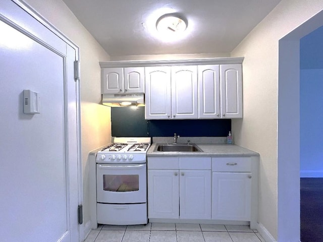 kitchen featuring sink, white cabinets, white gas stove, and light tile patterned flooring