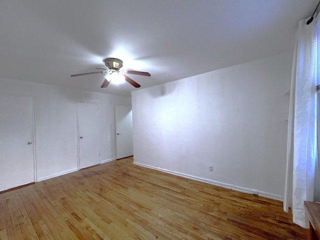 unfurnished room with ceiling fan and light hardwood / wood-style flooring