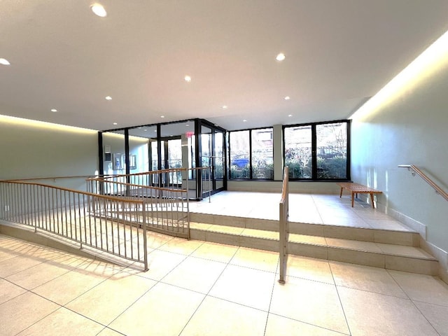 interior space with tile patterned flooring and a wall of windows