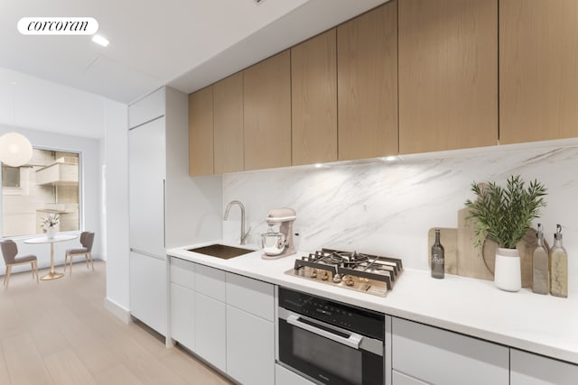 kitchen featuring sink, hanging light fixtures, tasteful backsplash, and stainless steel appliances