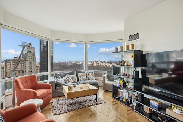 living area with a view of city and visible vents