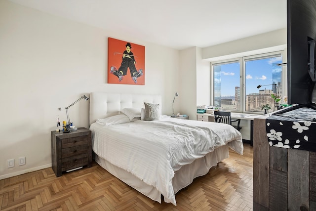 bedroom featuring a view of city, access to exterior, and baseboards